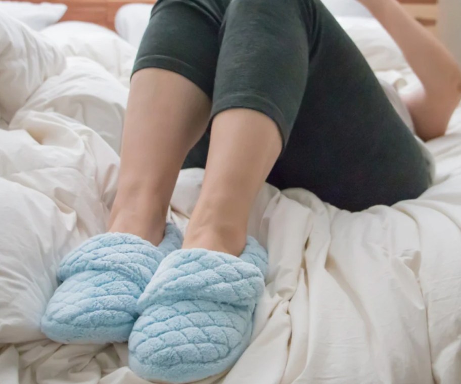 blue quilted slippers on feet