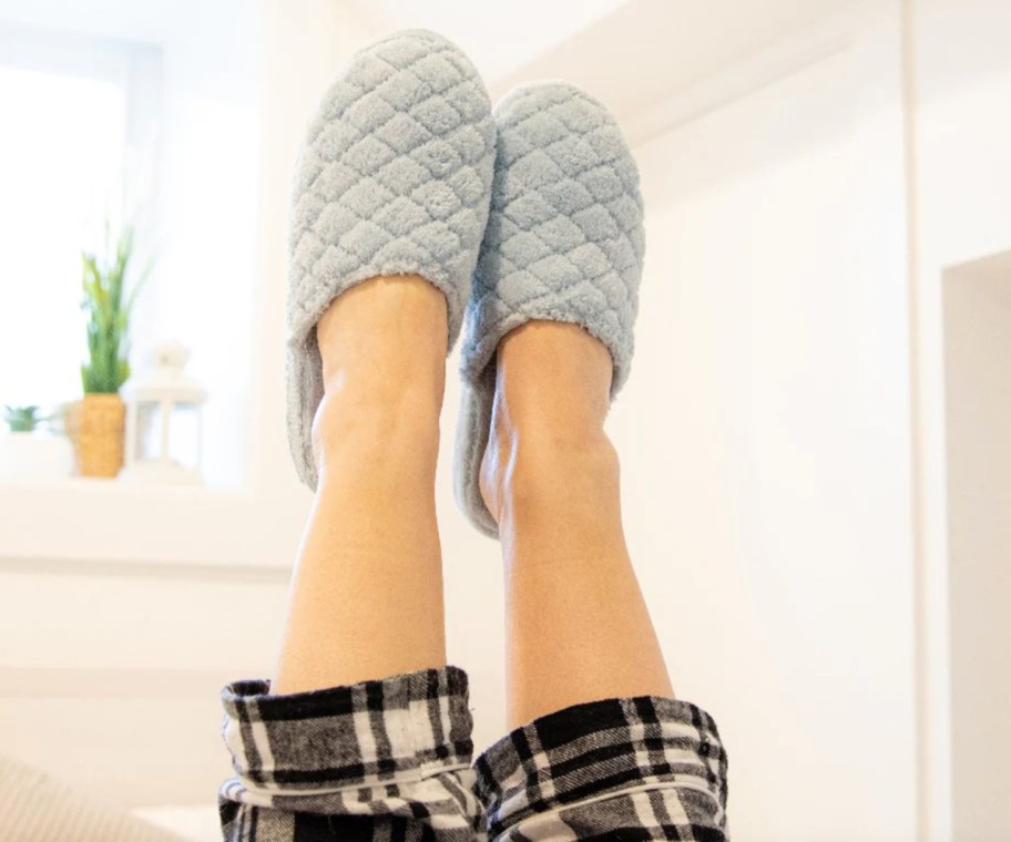 blue slippers on feet in air