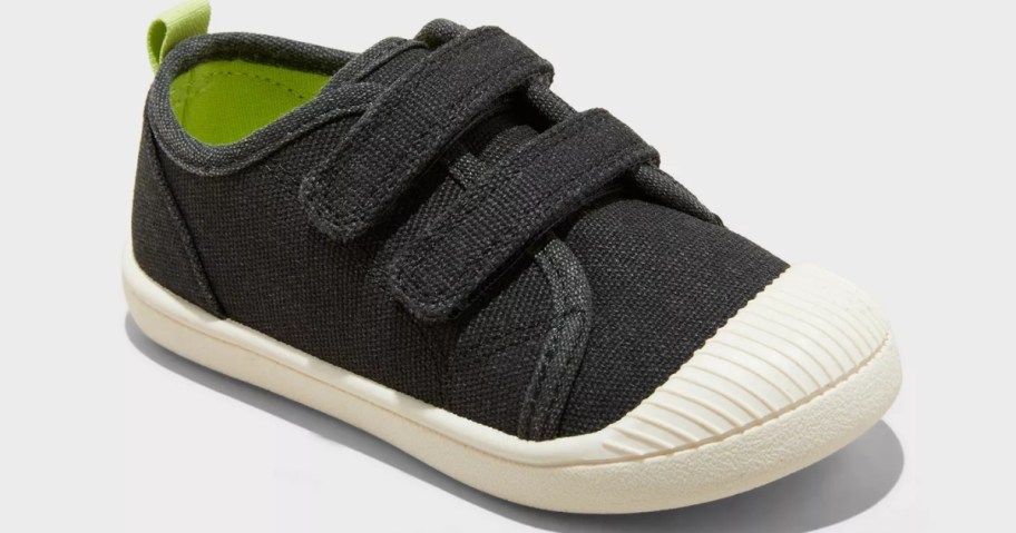 a toddler's black sneaker