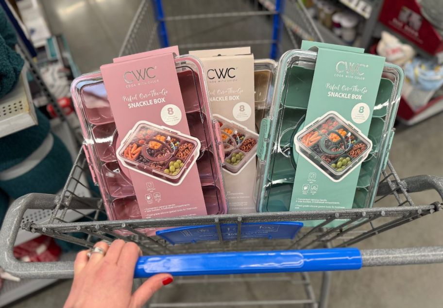 A walmart cart with 3 snackle boxes