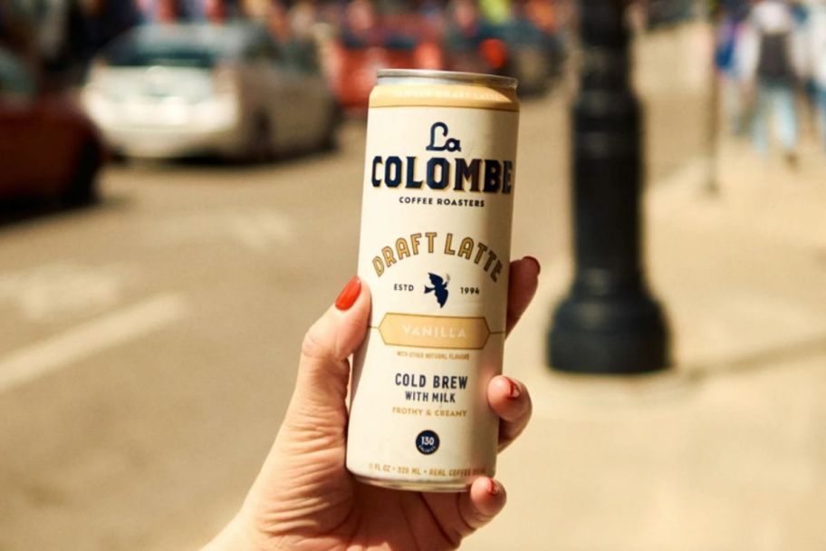 a hand holding a can of ready to drink coffee