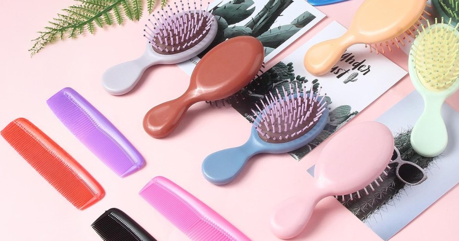 colorful mini hairbrushes and combs on a pink background