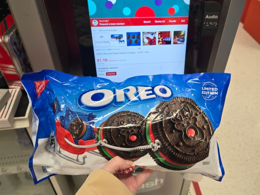 womans hand holding a bag of holiday oreos