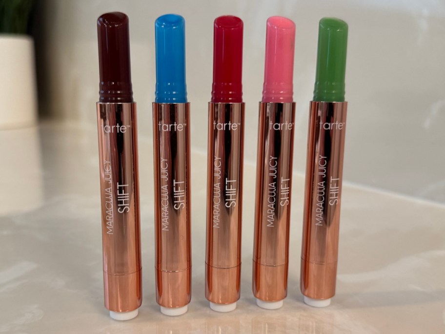 purple, blue, red, pink, and green lip balms 