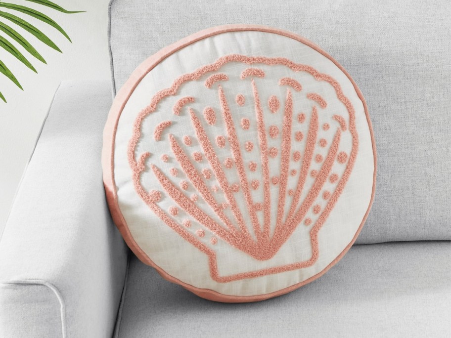 a seashell throw pillow on a couch