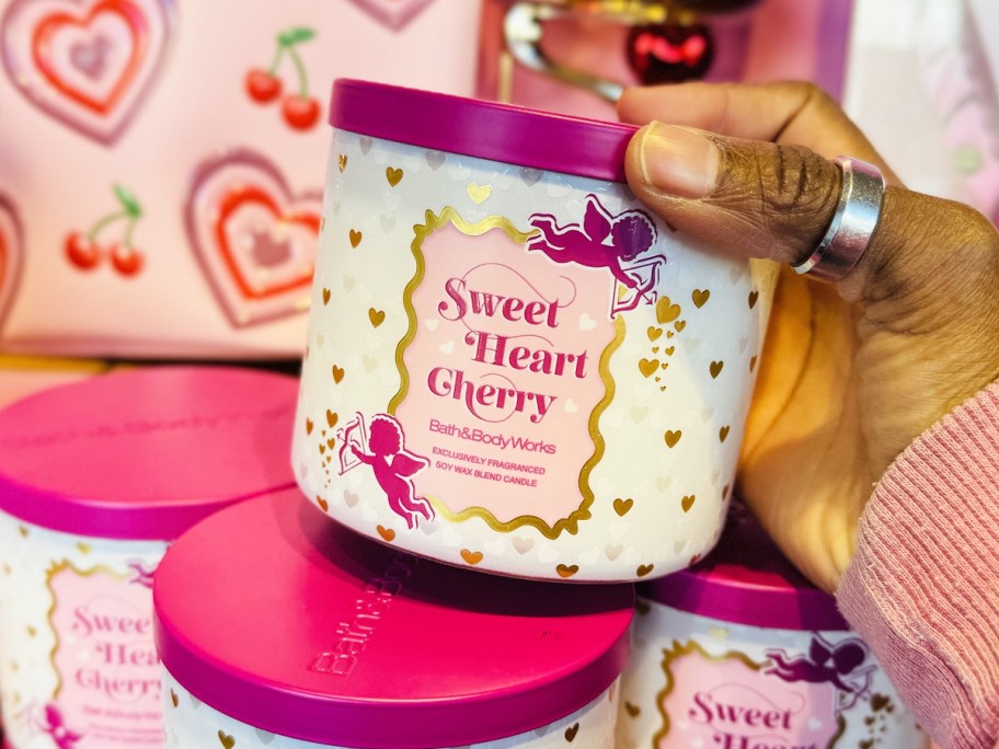 hand holding Bath & Body Works Sweetheart Cherry 3-Wick Candle