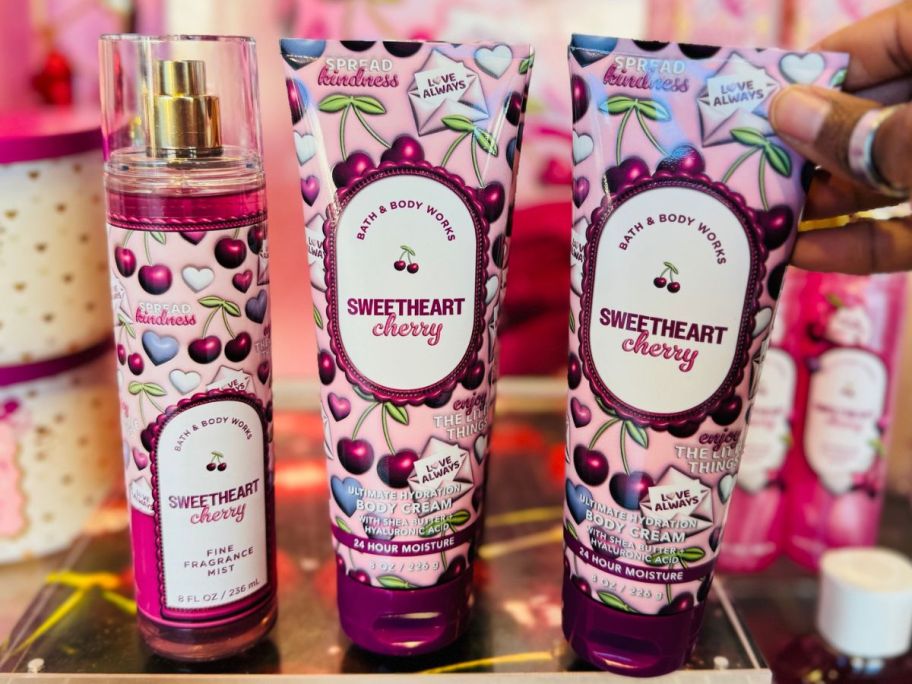 A Bottle of Bath & Body Works Sweetheart Cherry Fine Fragrance Mist and two body creams