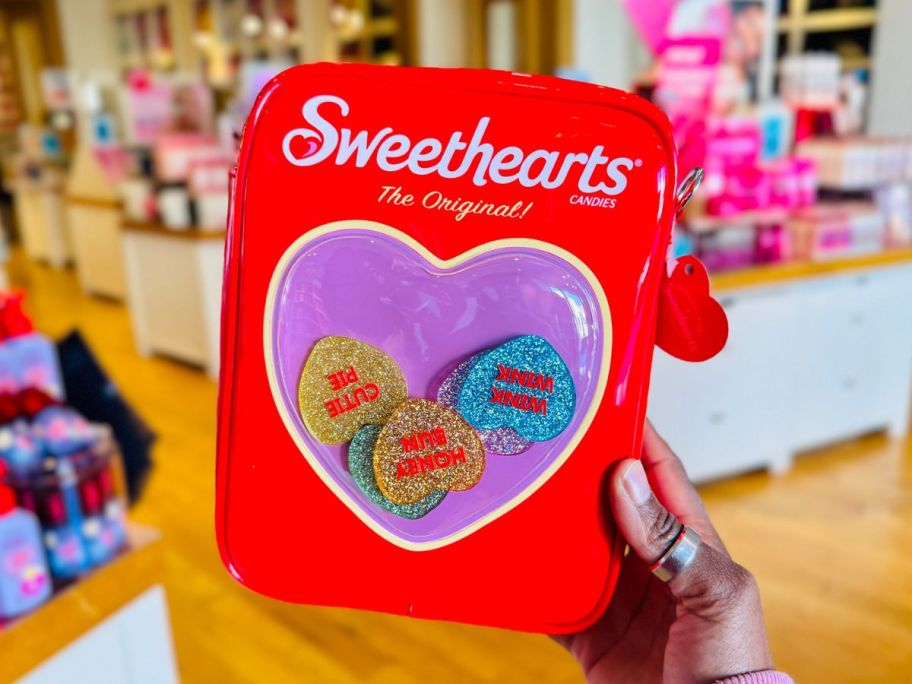 Hand holding a Bath & Body Works Sweethearts Cross Body Bag