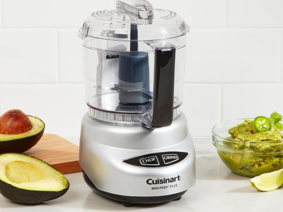 A Cuisinart Mini 3-Cup Food Processor surrounded by avocados 