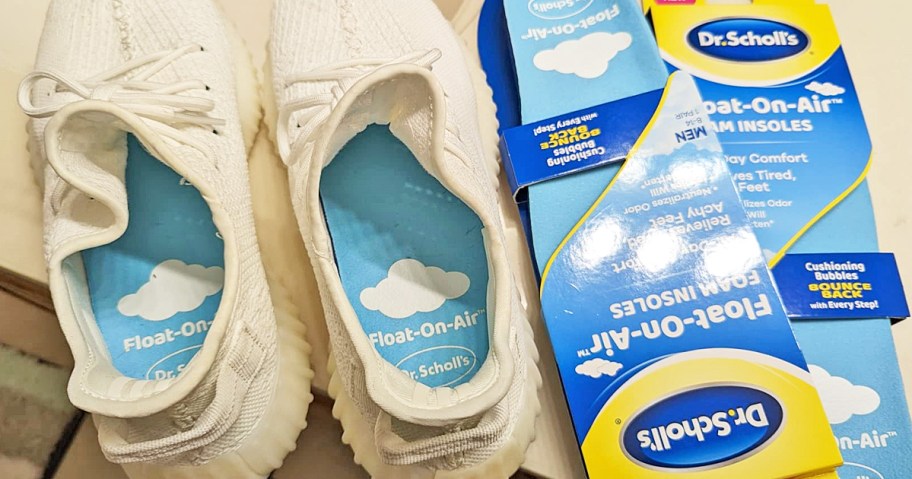 pair of shoes with Dr. Scholl's Men's Float-On-Air Comfort Insoles inside next to its packaging