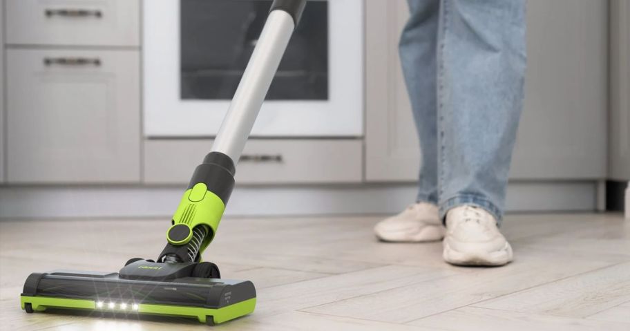 someone pushing a GleeU Cordless Stick Vacuum Cleaner