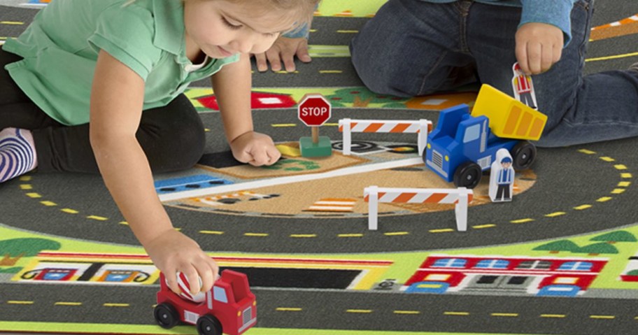Melissa & Doug Jumbo Roadway Activity Rug being played with by two children