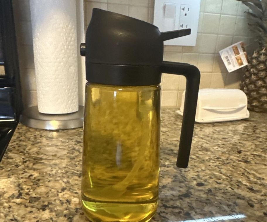 An olive oil dispenser bottle on a counter