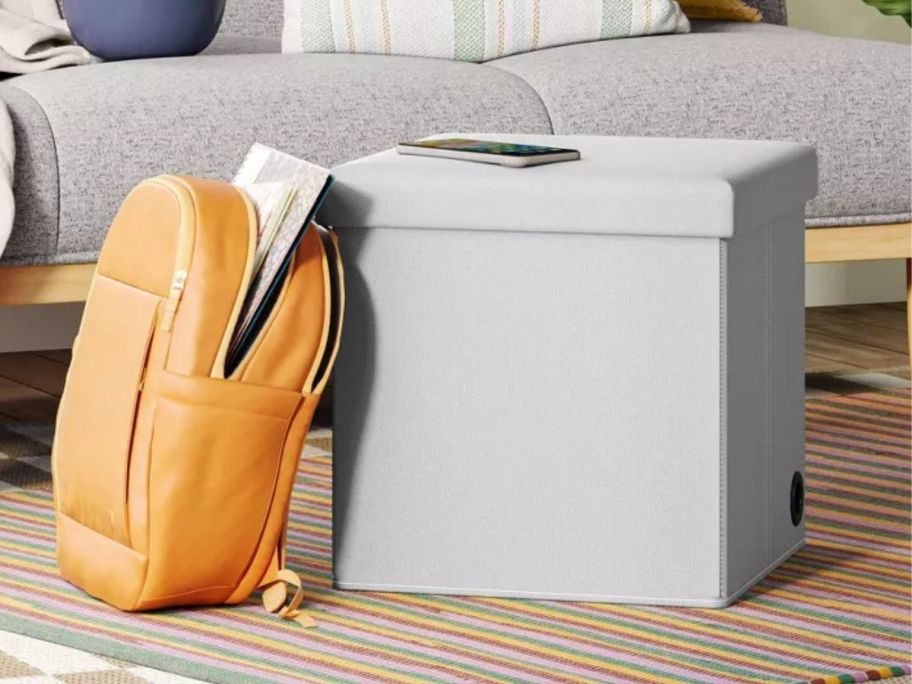 A Room Essentials Collapsible Storage Ottoman in a living room