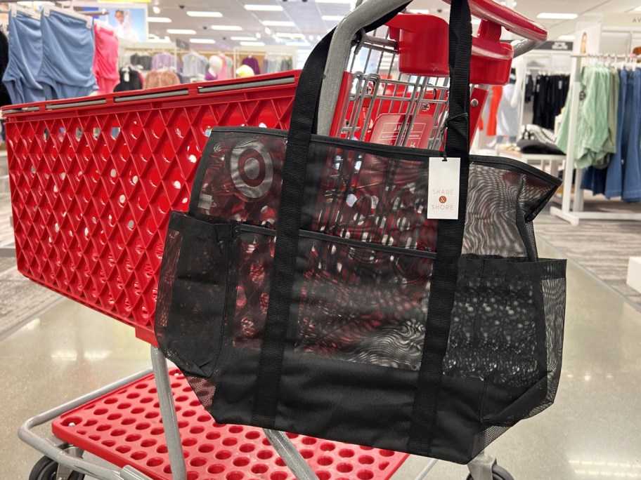 black mesh tote bag hanging from red target shopping cart
