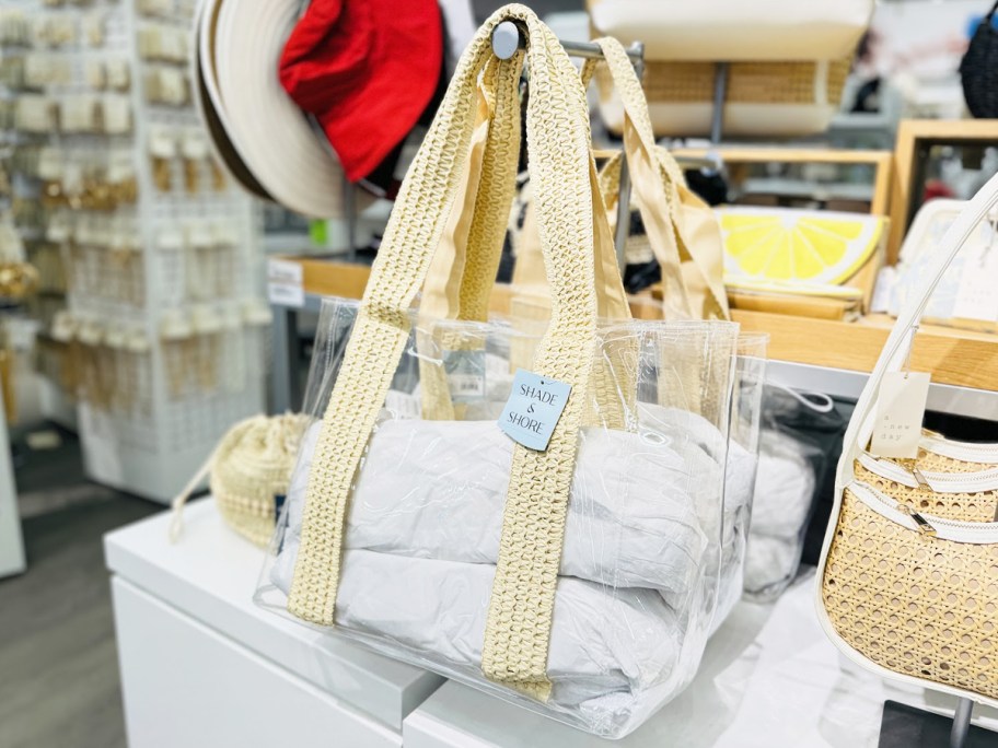 clear tote bag with woven straps on display in store