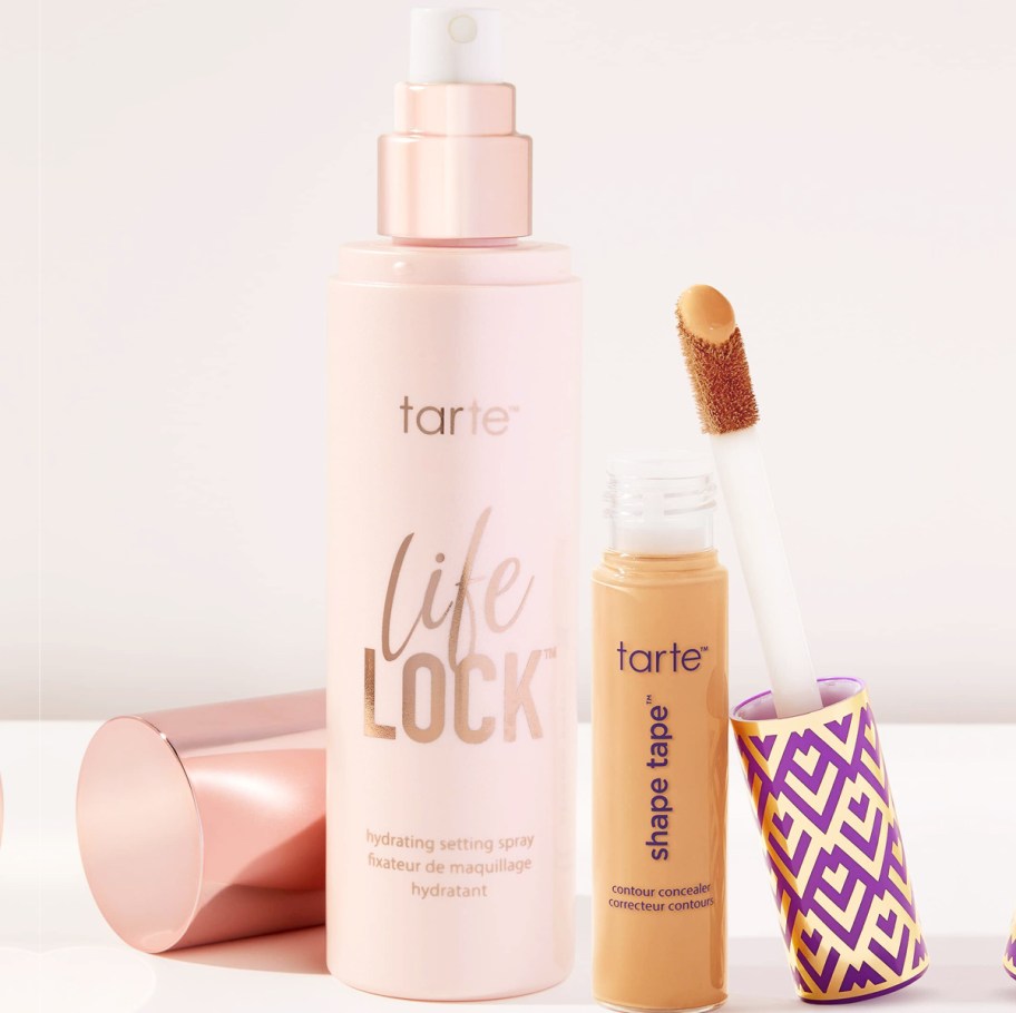 bottle of setting spray and tube of shape tape concealer