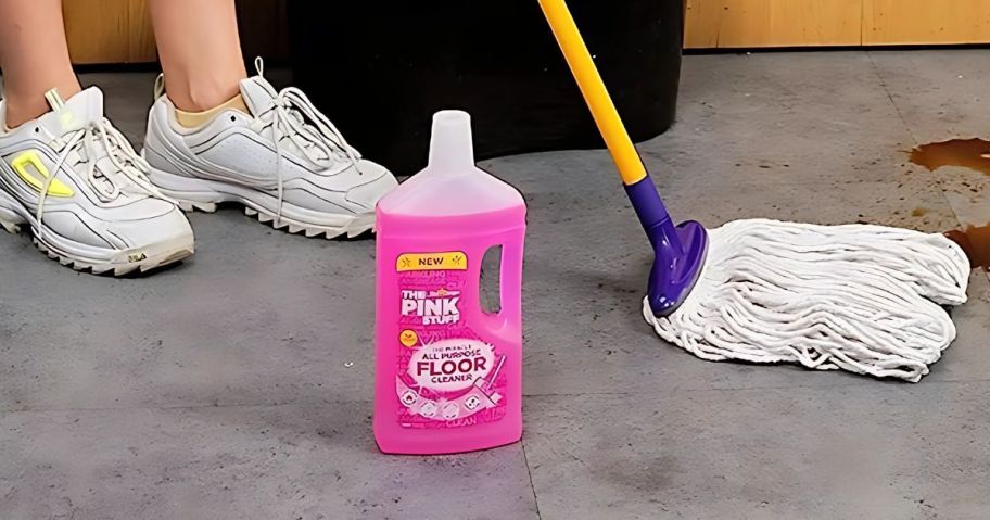 A woman cleaning the floor with The Pink Stuff Floor Cleaner Bottle