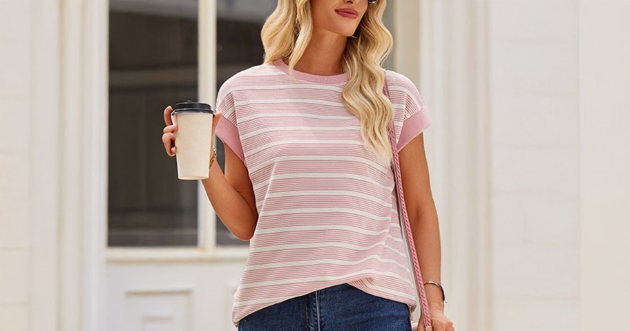 Women's Cap Sleeve Crewneck Top being worn by a lady walking down the street holding a coffee
