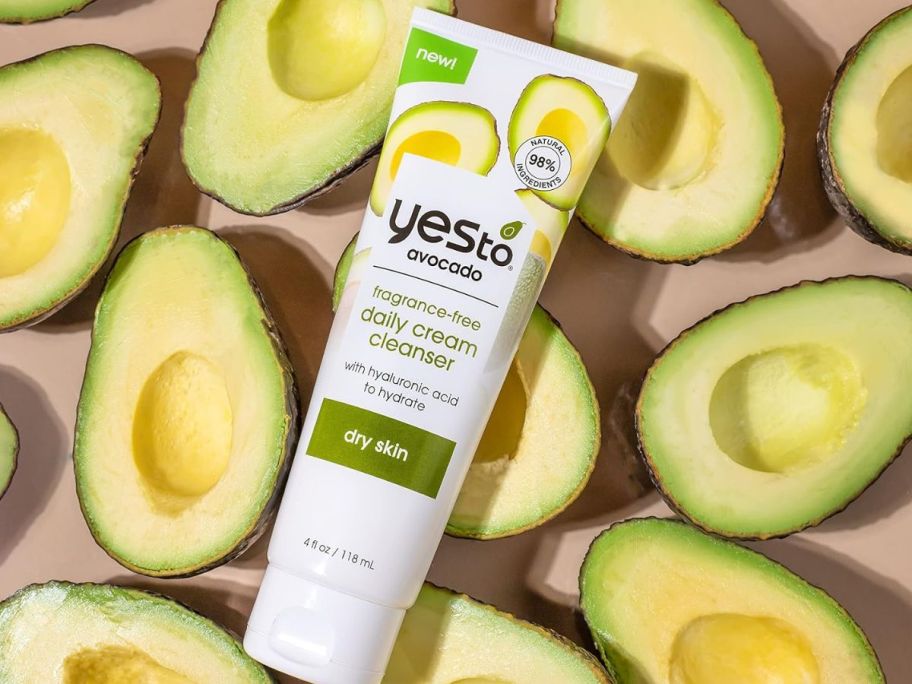 A tube of cleaner in the middle of avocados 