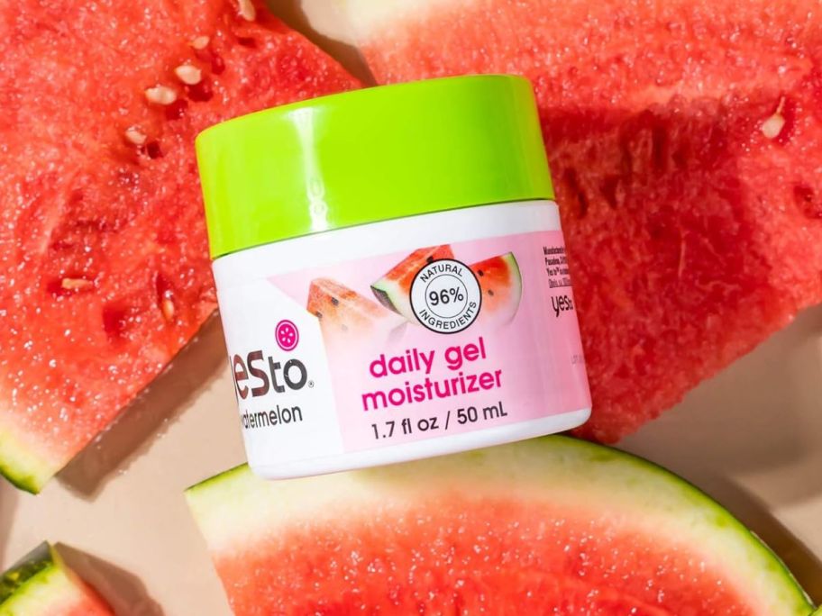 a canister of moisturizer among pieces of watermelon