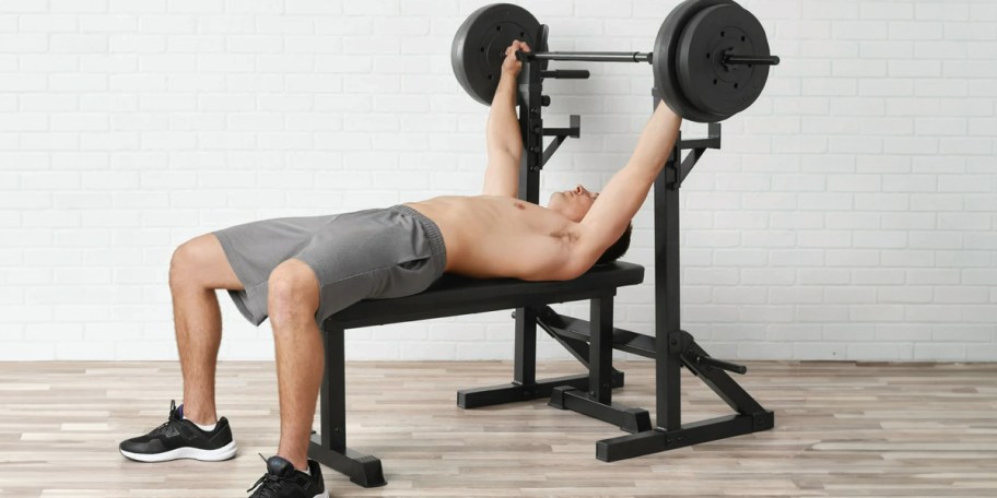 man lifting weight on squat bench