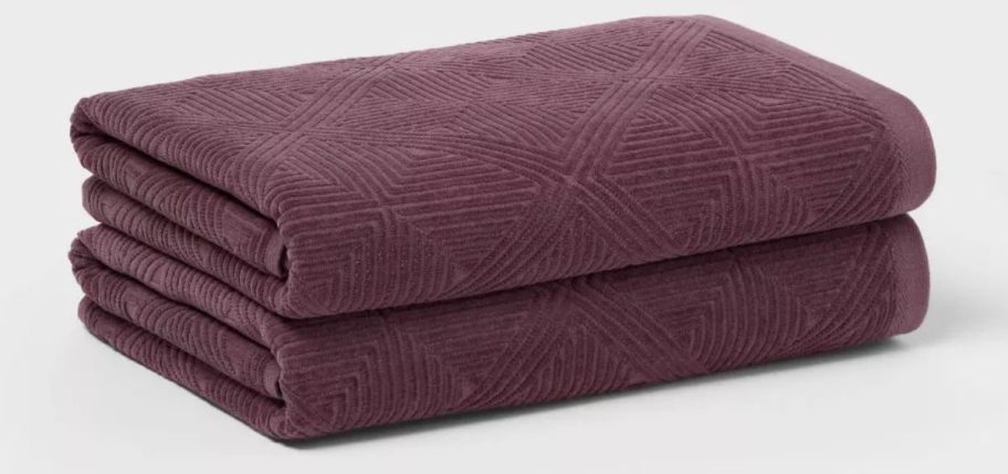 two wine colored Threshold Luxe Lattice Towels stacked on top of each other
