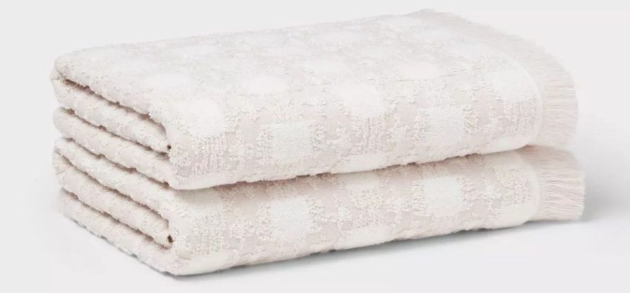 two cream colored Threshold Boho Ikat Patterned Towels stacked on top of each other
