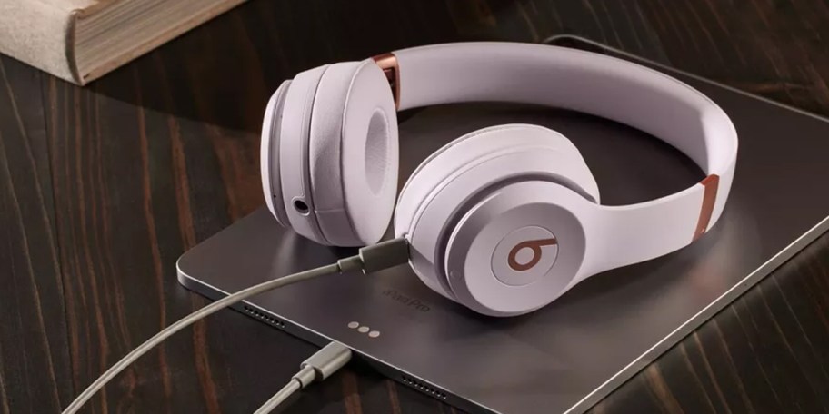 light purple solo 4 headphones laying on tablet