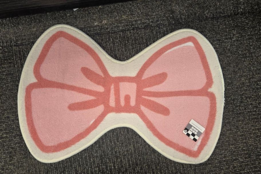 a pink bow shaped bathroom rug