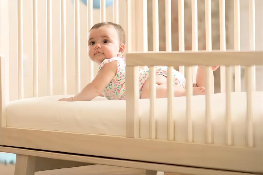 baby laying in a white baby crib