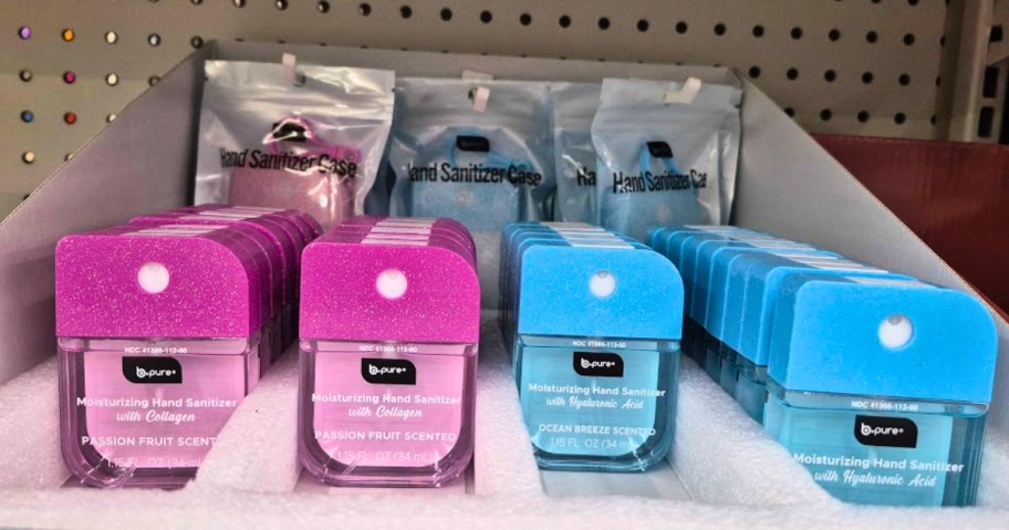 small containers of hand sanitizer and packs of cases on a store shelf
