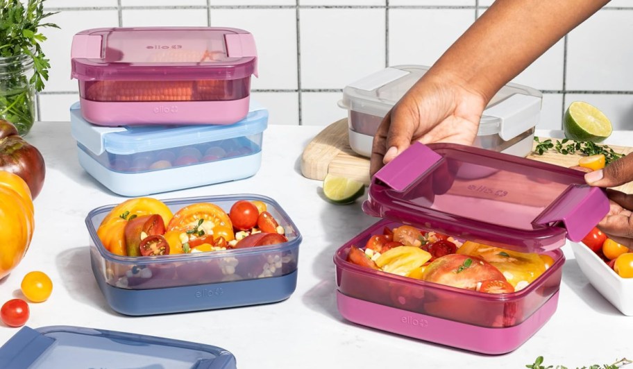 hand reaching for ello container among assorted containers