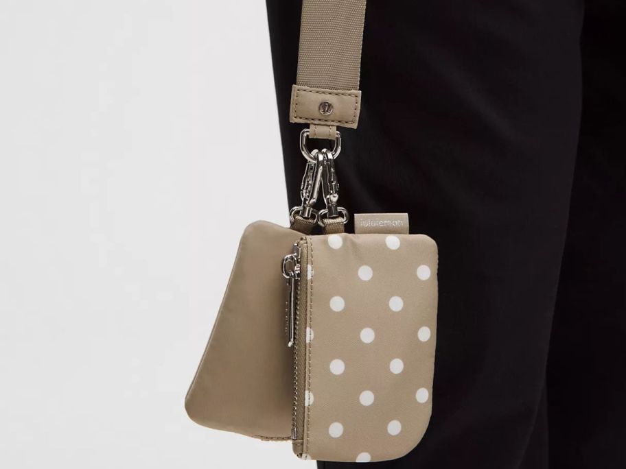 hand holding lululemon Dual Pouch Wristlet