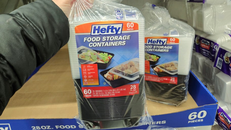 hand lifting a package of hefty food storage containers off a sams club display