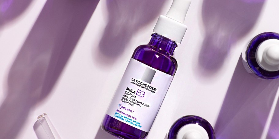 la roche dark spot serum bottle laying on table