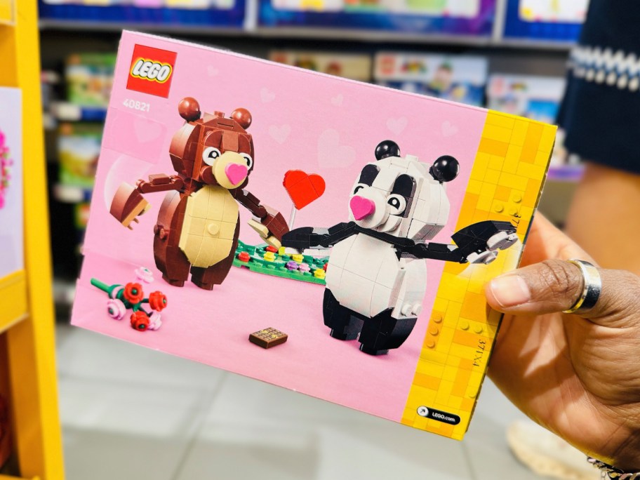 hand holding lego bear and panda set