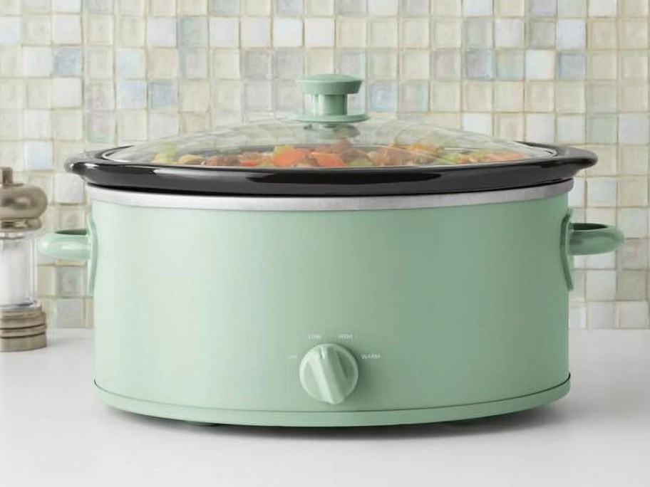 green mainstays slow cooker on table