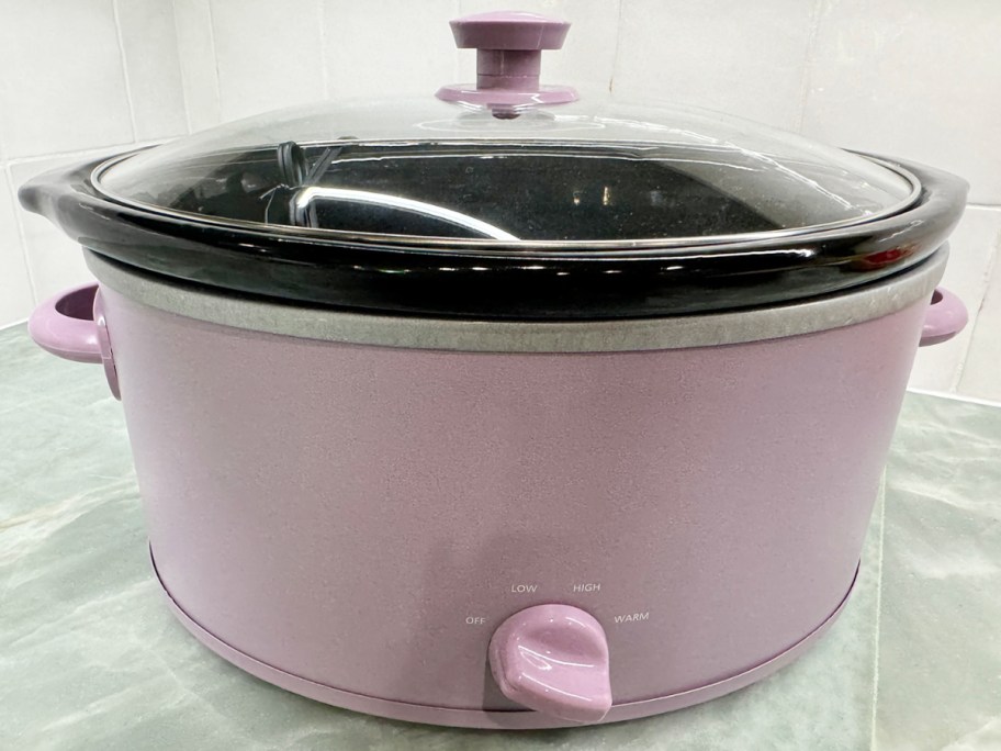 purple slow cooker on table