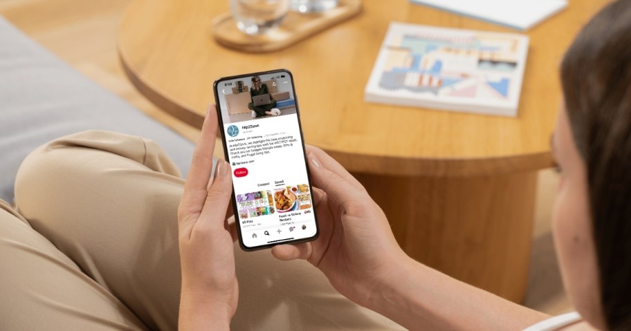 hand holding phone with Pinterest profile on screen