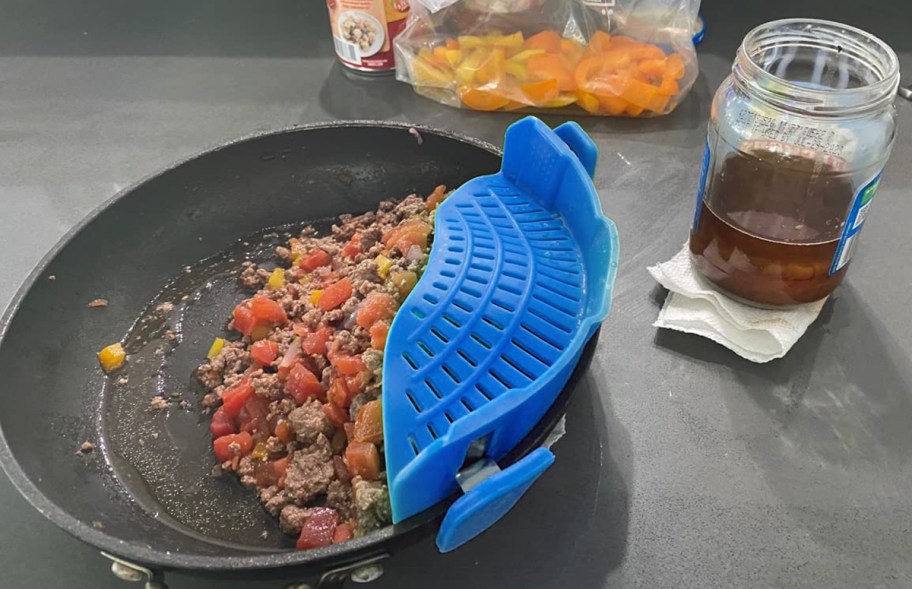 strainer on a pan of food on the counter