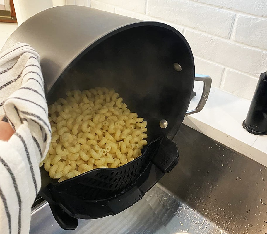 pouring out a pan of noodles into a strainer