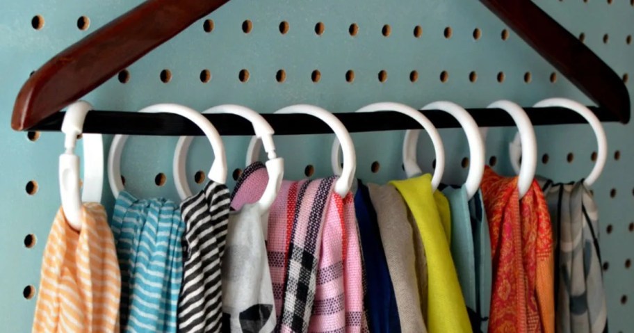 scarves hanging from hanger with white circle rings