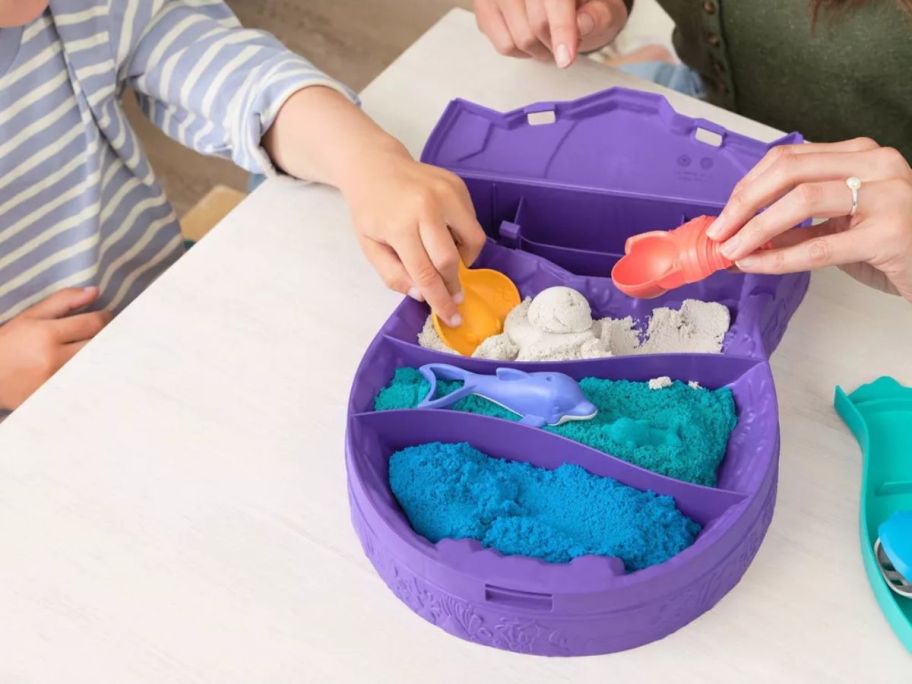 kids playing with Kinetic Sand Deep Sea Dive on table