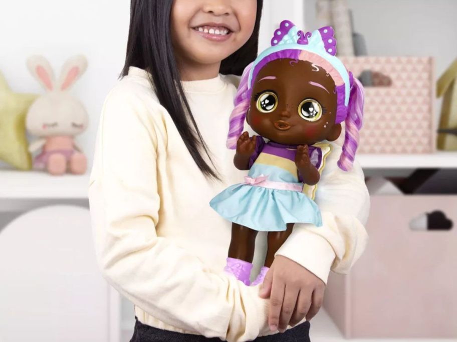 girl holding Cry Babies Emma's Morning Routine Interactive Baby Doll