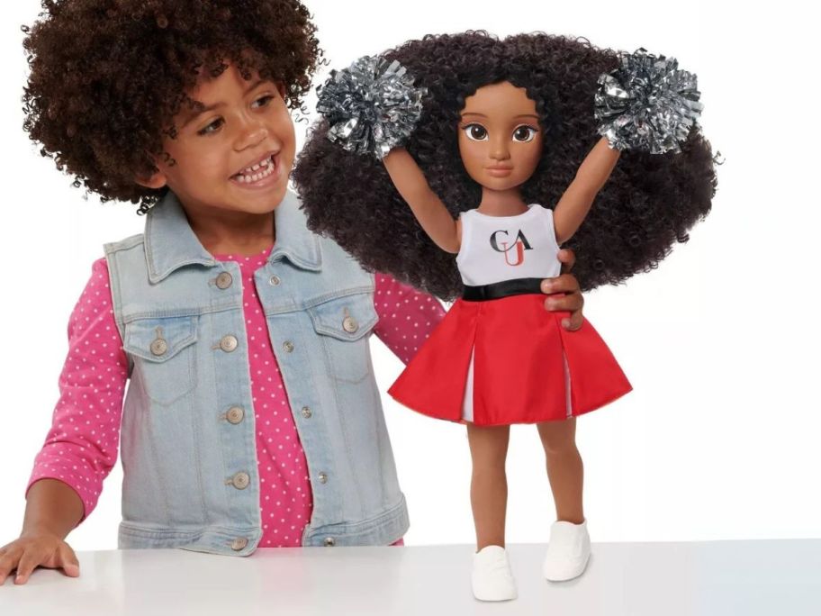 girl looking at HBCyoU Clark Cheer Captain Doll on table