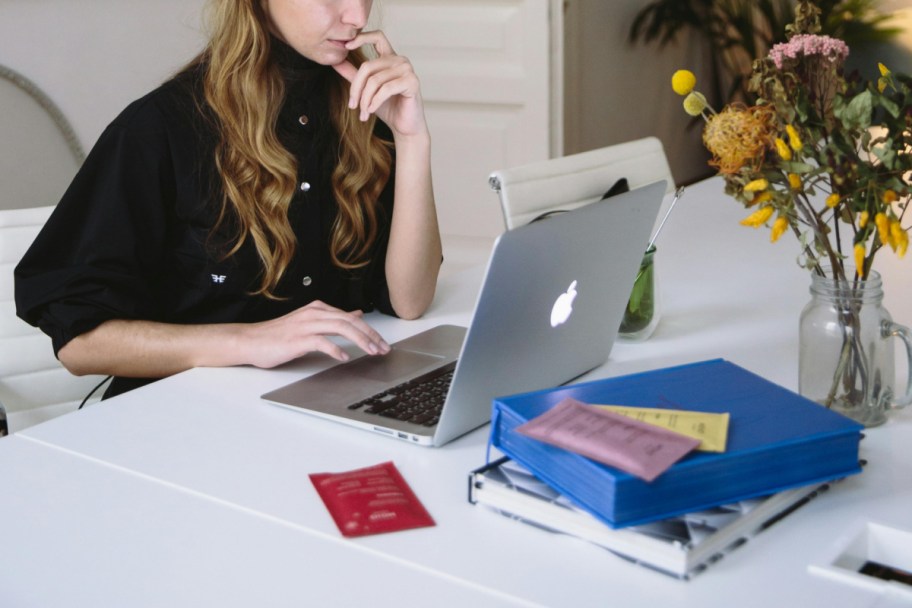 woman sitting on laptop at table