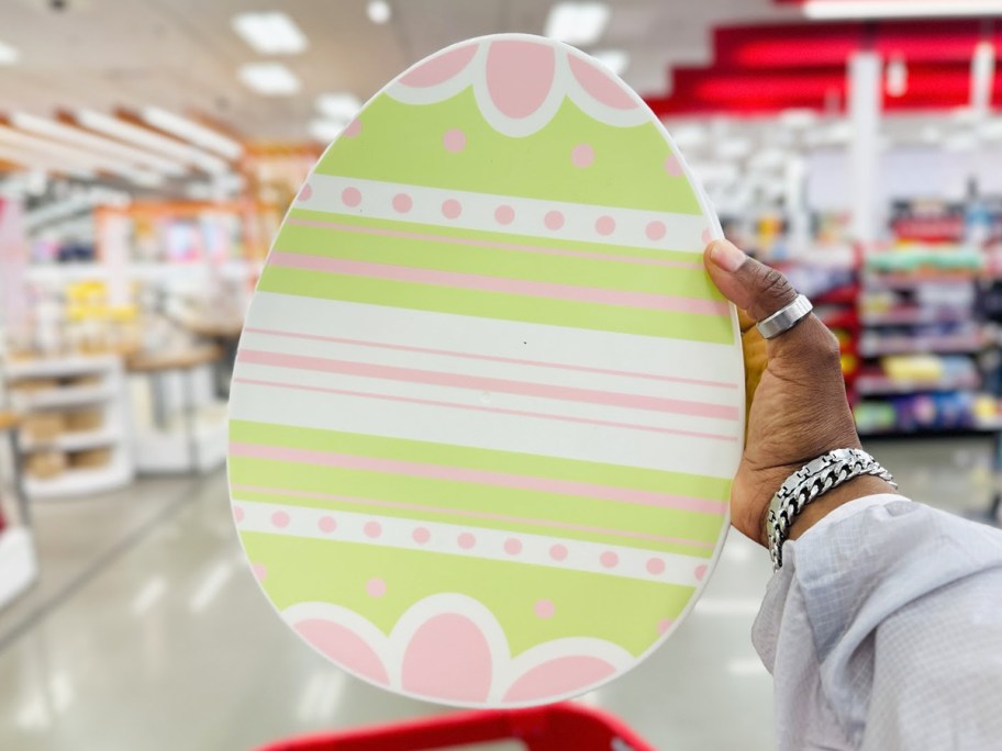 hand holding up an egg shaped snackle box in store