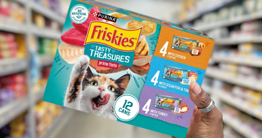 hand holding up a box of Friskies Tasty Treasures Wet Cat Food cans in store