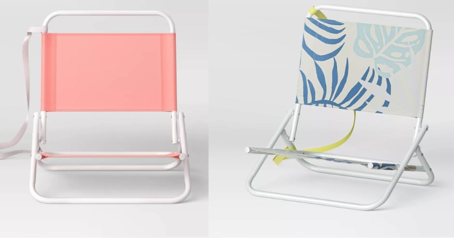 a coral and white beach chair and a white with palm leaves print beach chair
